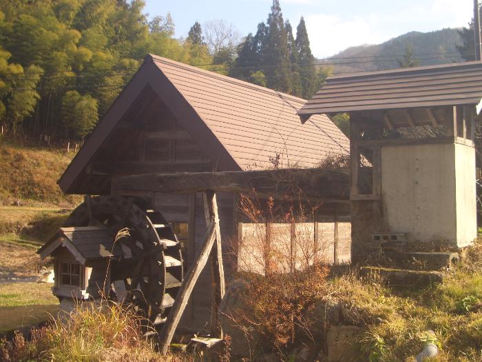 山の中にある水車のついた小屋の写真
